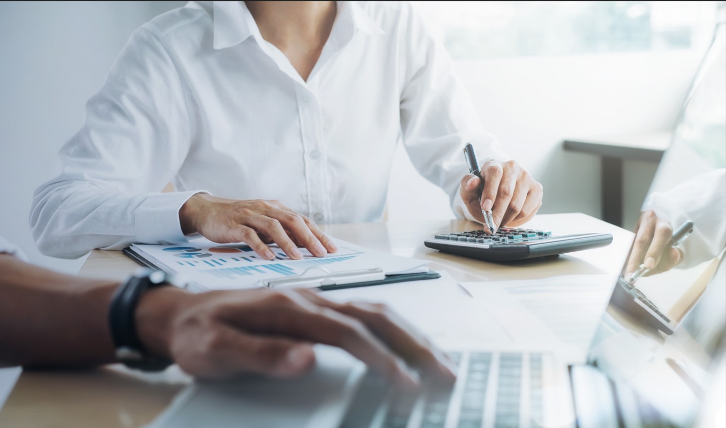 Two people sitting at a table reviewing documents