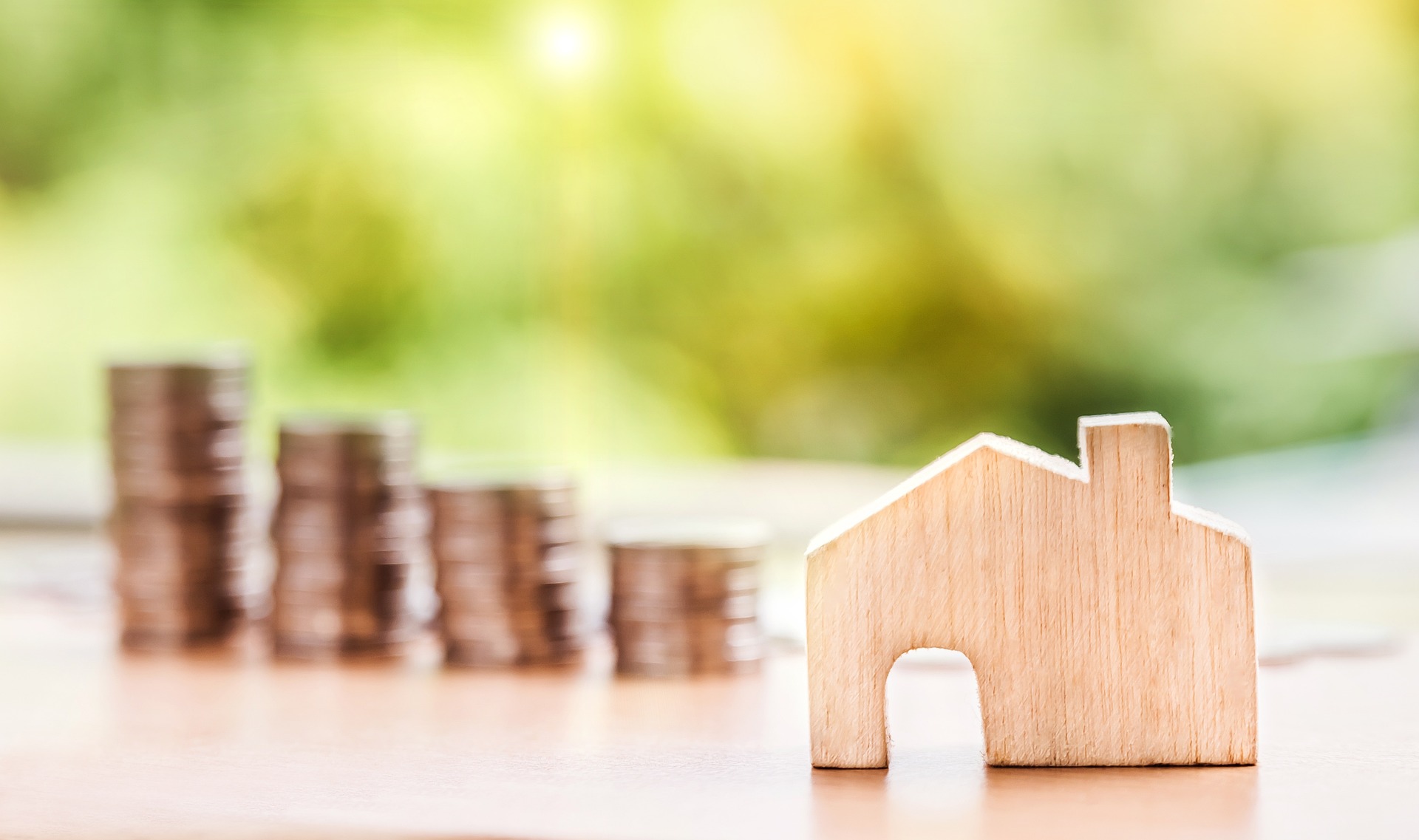 A wooden house in front of several piles of change