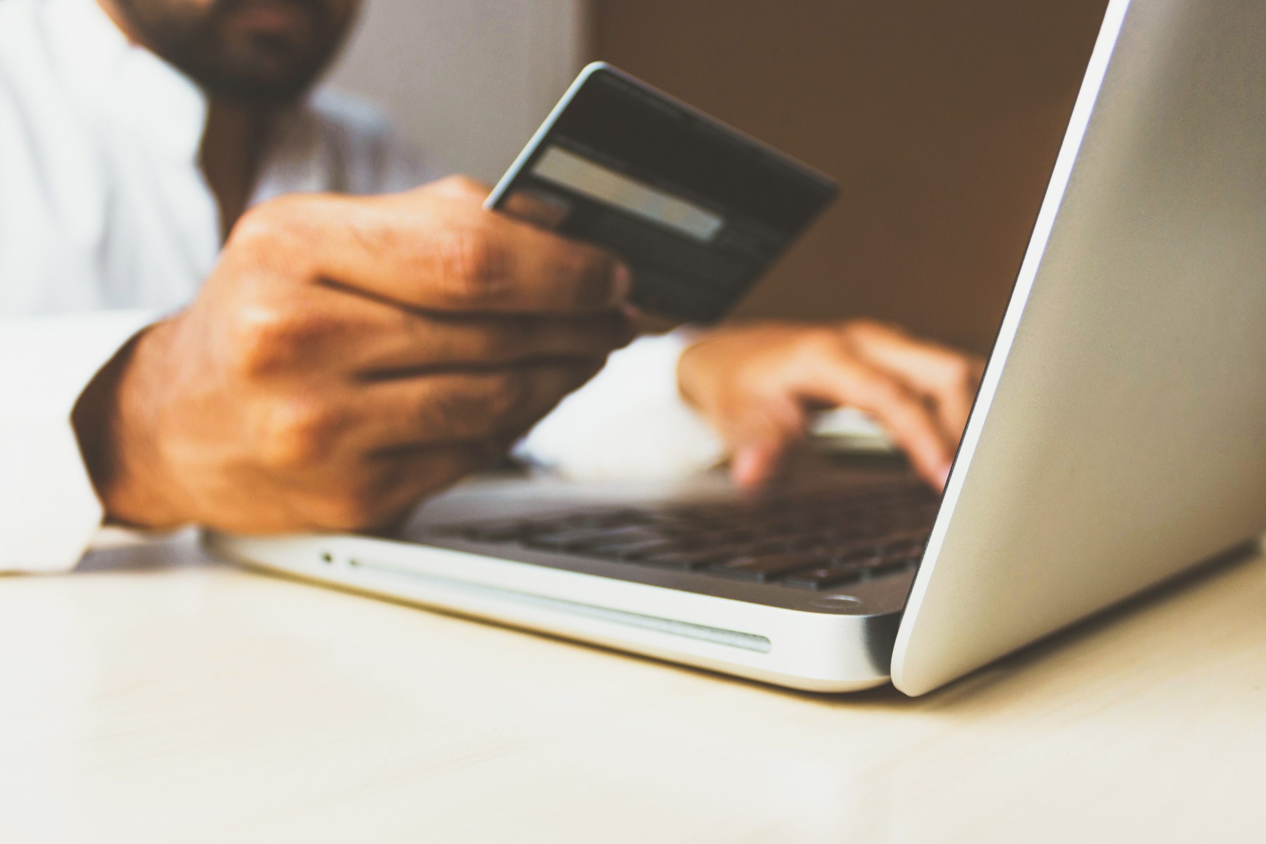 Person entering credit card information on a computer.