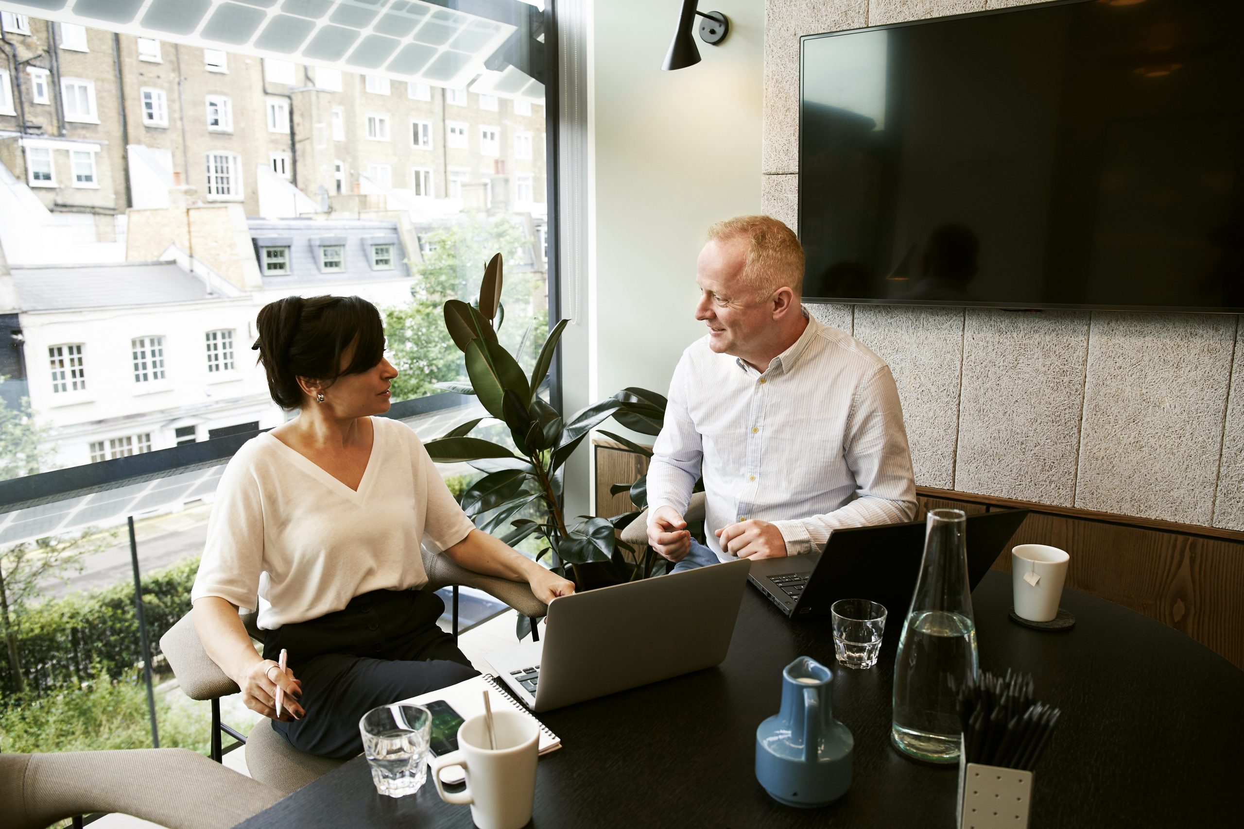 Man and woman having a discussion at a table