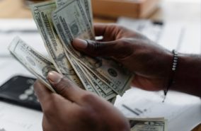 A person holding money in their hands