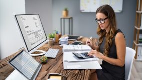 A business owner looks over their invoices for accounts receivable.