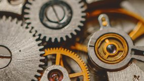 A detailed image of the internal gears of a mechanical watch.